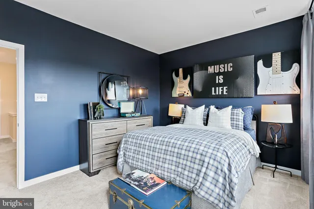 a bedroom with a bed and a dresser