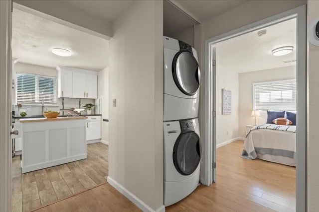 a bedroom with a bed a mirror and a window