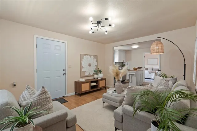 a living room with furniture and a chandelier