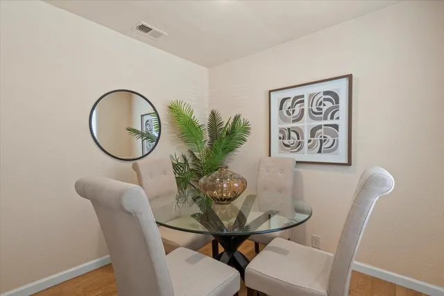 a view of a dining room with furniture and a potted plant