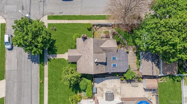 an aerial view of a house with a garden and a yard