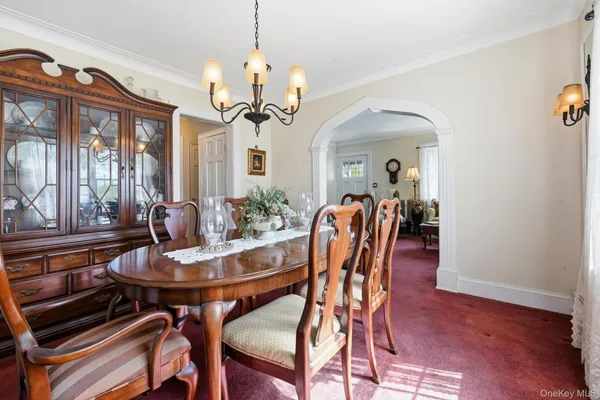 a view of a dining room with furniture wooden floor and chandelier