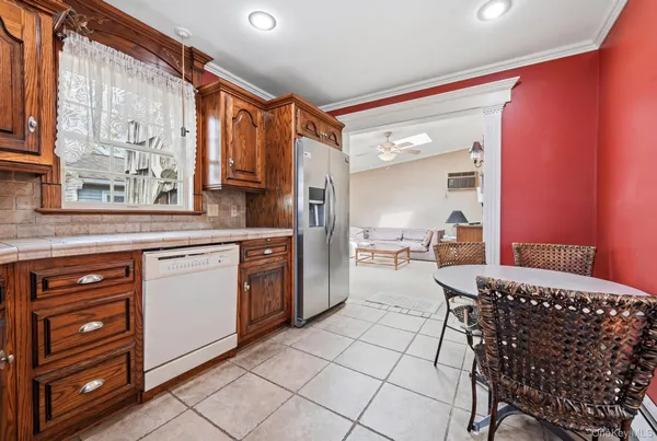 a kitchen with granite countertop a sink cabinets and appliances