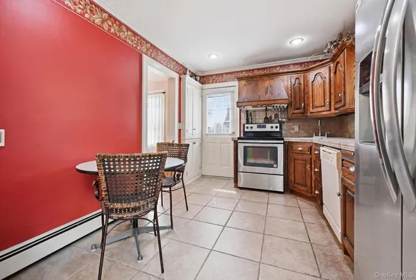 a kitchen with stainless steel appliances granite countertop a stove a sink dishwasher and a refrigerator