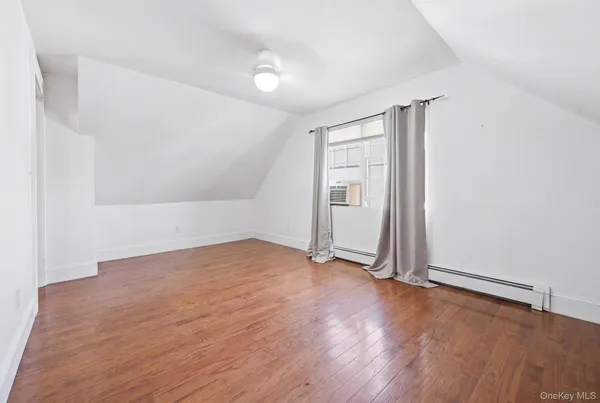 an empty room with wooden floor