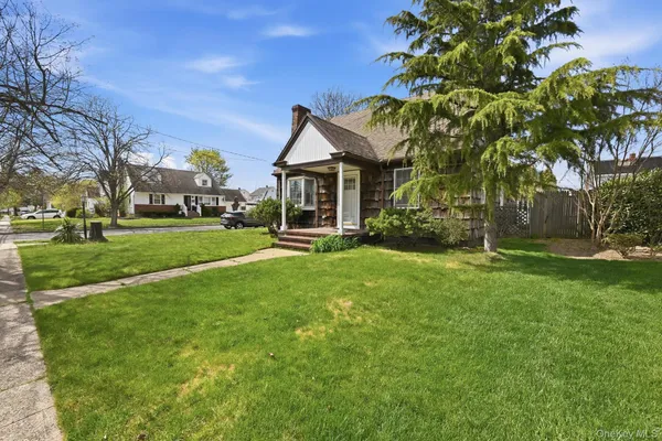 a front view of house with yard and green space