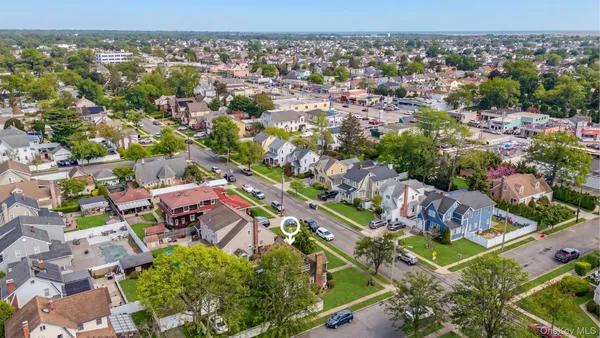 an aerial view of residential houses with outdoor space