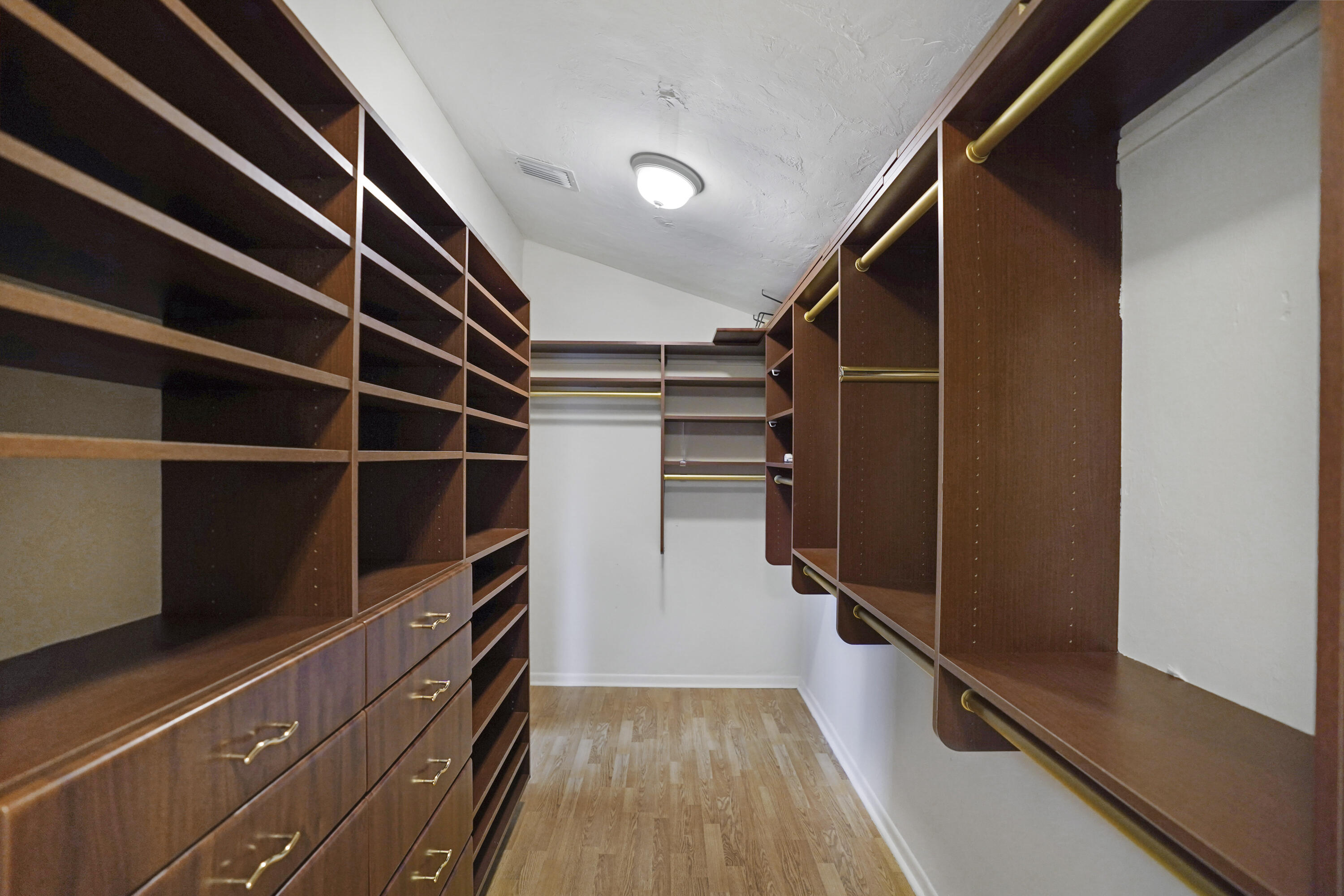 2674 Northwest 41st Street Boca Raton, FL 33434 - Photo 32 of 48 a view of walk in closet with clothes and shoes