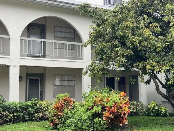 front view of a house with a garden