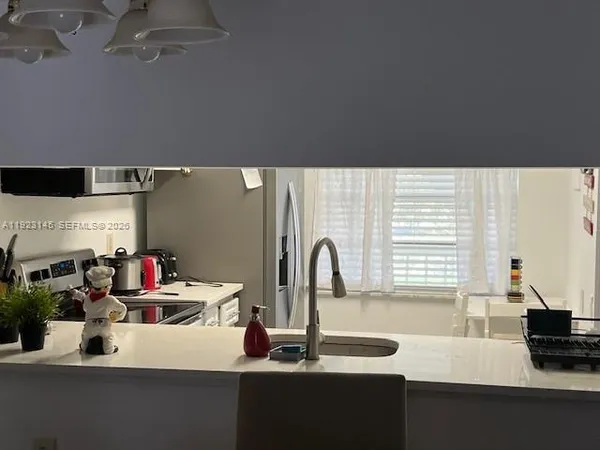 a kitchen with a sink and a stove top oven