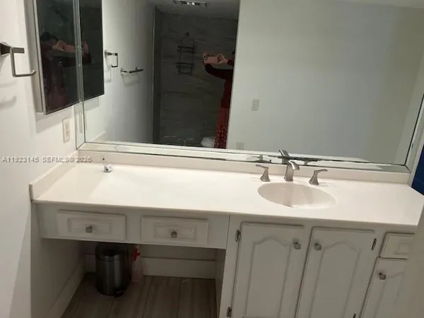 a bathroom with a sink and a mirror