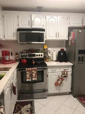 a kitchen with a stove and a microwave