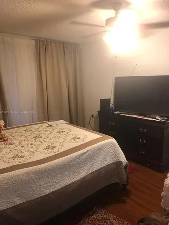 a bedroom with a bed and a night stand