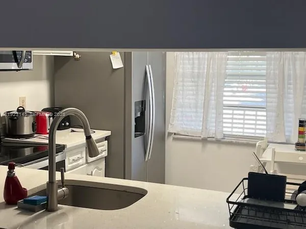 a view of a kitchen with a sink and cabinets