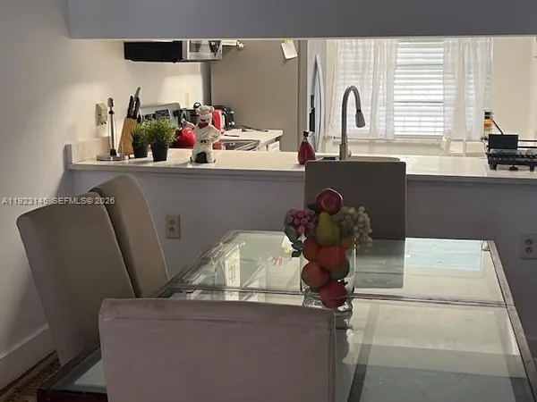 a dining room with furniture and window