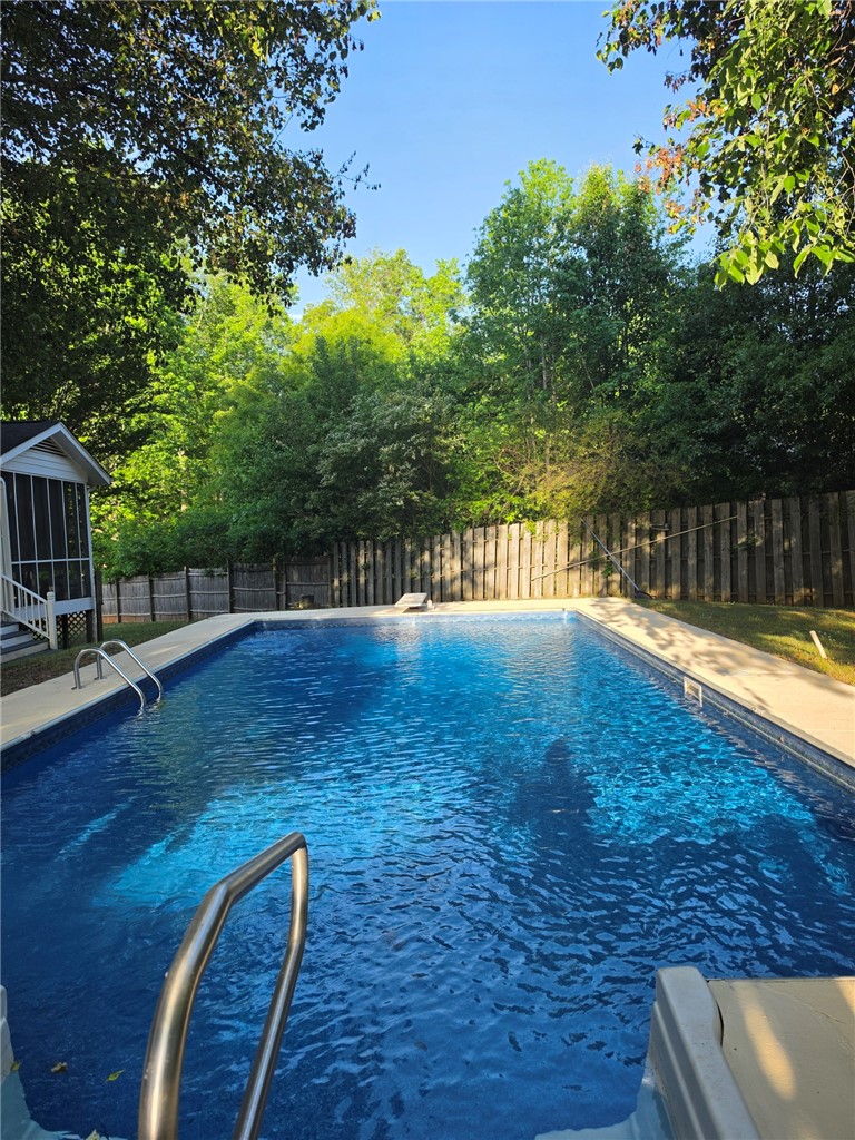 224 Regency Circle Anderson, SC 29625 - Photo 36 of 43 This tranquil outdoor pool provides a refreshing escape surrounded by lush greenery.