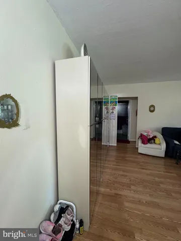 a view of a bedroom with furniture and a mirror