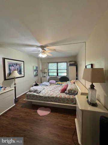 a bedroom with bed and a chandelier