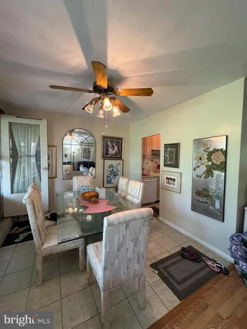 a view of a dining room with furniture wooden floor and chandelier