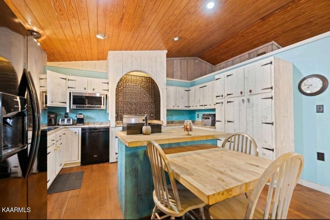2122 Northwest Old River Road Charleston, TN 37310 - Photo 17 of 28 a very nice looking open dining room with kitchen island a stove a table and a refrigerator