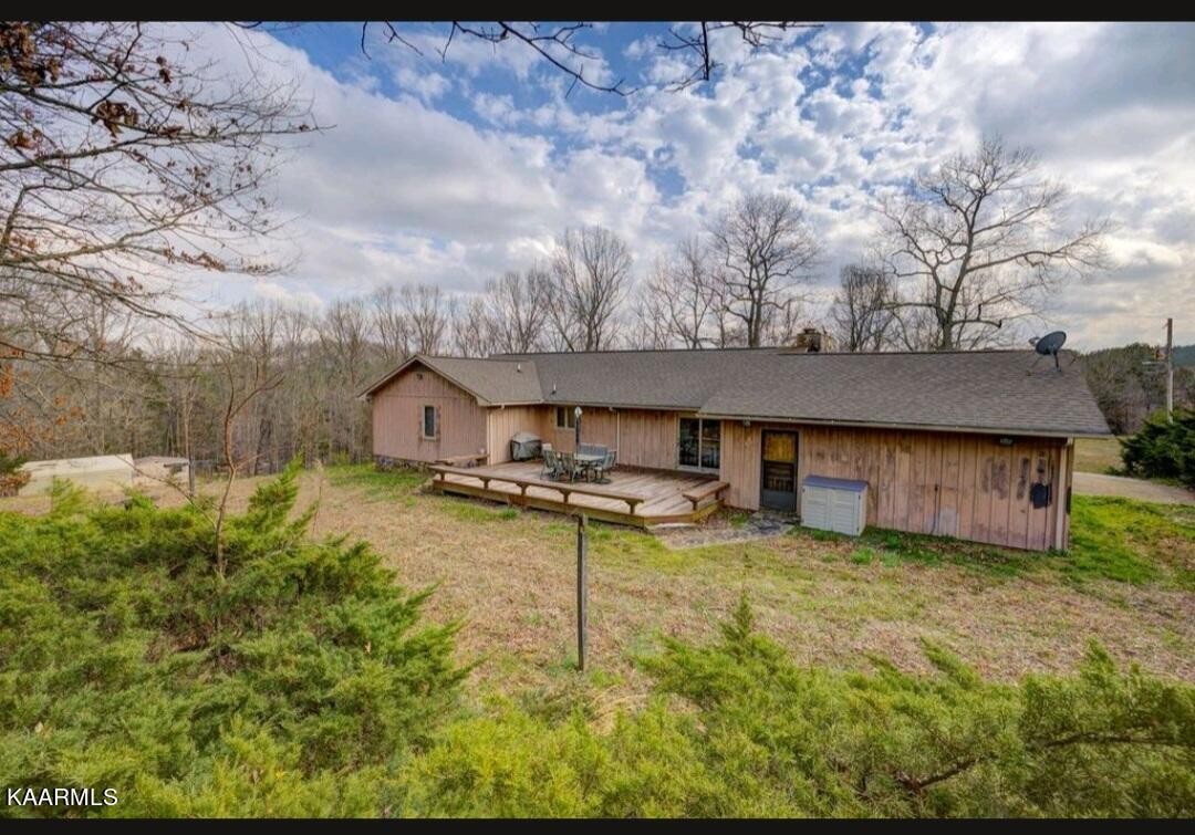 2122 Northwest Old River Road Charleston, TN 37310 - Photo 7 of 28 a backyard of a house with table and chairs