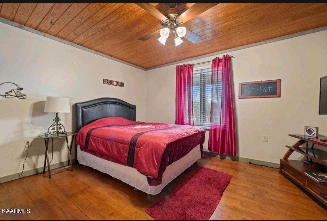 2122 Northwest Old River Road Charleston, TN 37310 - Photo 8 of 28 a spacious bedroom with a bed and a chandelier