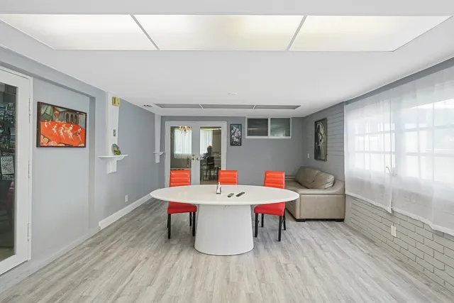 a room with pool table and windows