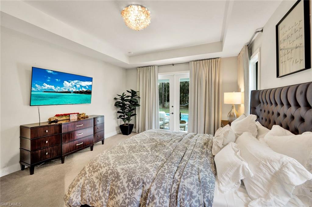 3700 11th Avenue Southwest Naples, FL 34117 - Photo 14 of 50 a bedroom with furniture and a flat screen tv