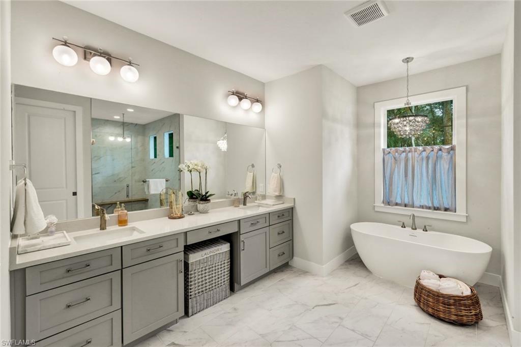 3700 11th Avenue Southwest Naples, FL 34117 - Photo 15 of 50 a spacious bathroom with a double vanity sink and a mirror