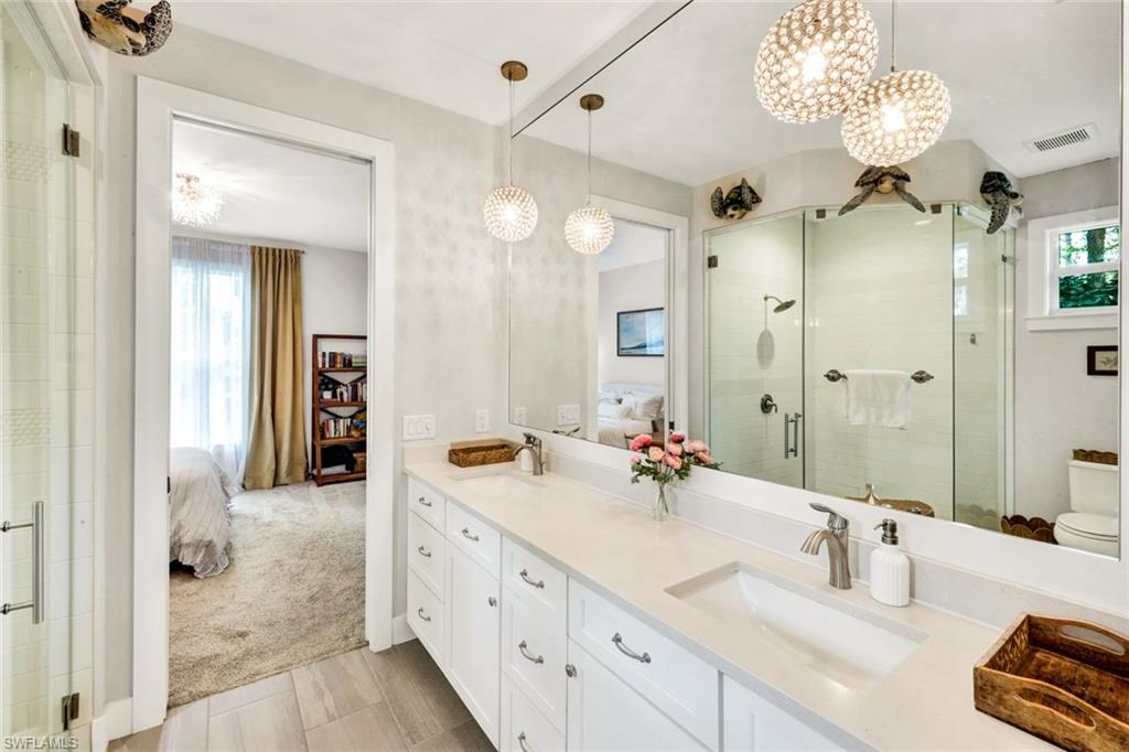 3700 11th Avenue Southwest Naples, FL 34117 - Photo 18 of 50 a bathroom with a double vanity sink mirror and shower