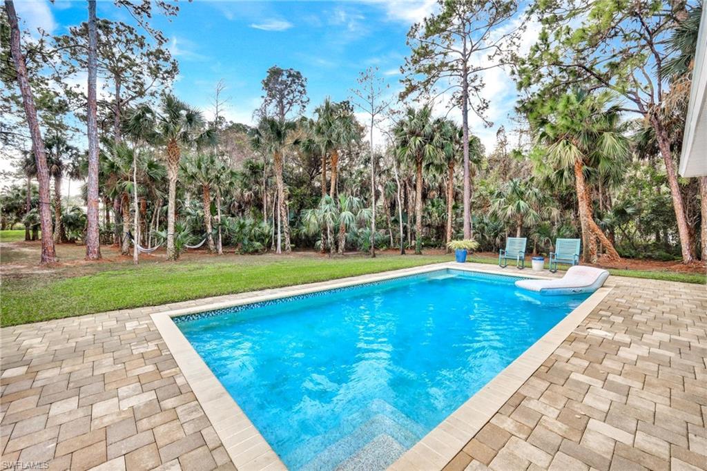 3700 11th Avenue Southwest Naples, FL 34117 - Photo 2 of 50 a view of swimming pool with an outdoor space and seating area
