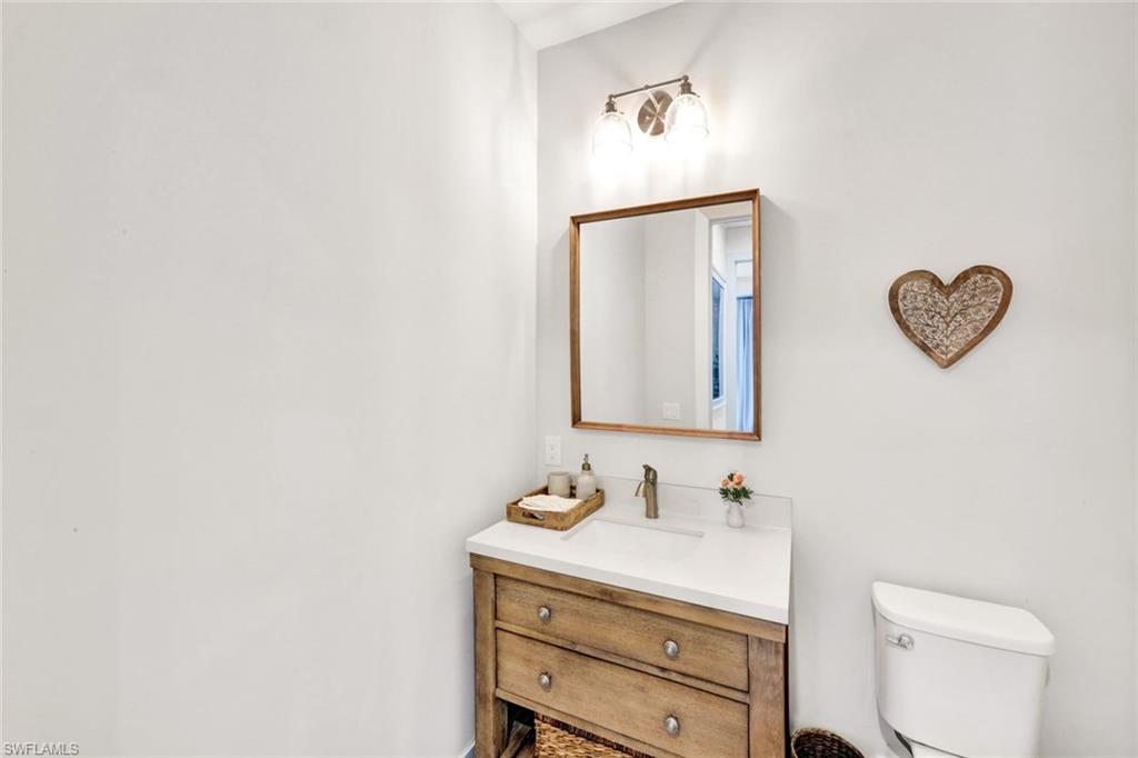 3700 11th Avenue Southwest Naples, FL 34117 - Photo 20 of 50 a bathroom with a toilet sink vanity and mirror