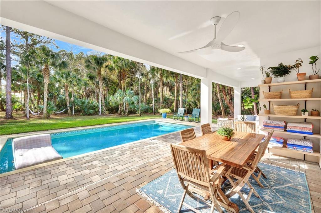 3700 11th Avenue Southwest Naples, FL 34117 - Photo 23 of 50 a patio with yard table and chairs