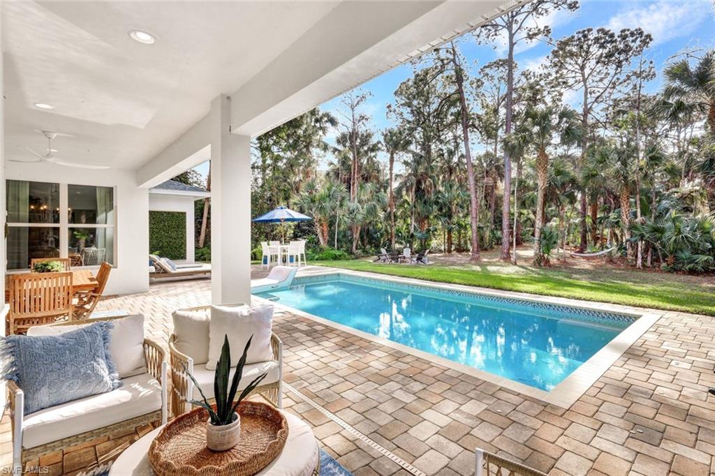3700 11th Avenue Southwest Naples, FL 34117 - Photo 24 of 50 a swimming pool with outdoor seating and yard