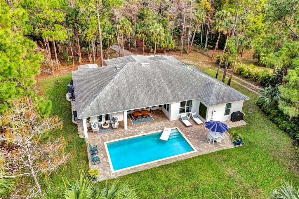3700 11th Avenue Southwest Naples, FL 34117 - Photo 3 of 50 an aerial view of a house with swimming pool garden view and trees