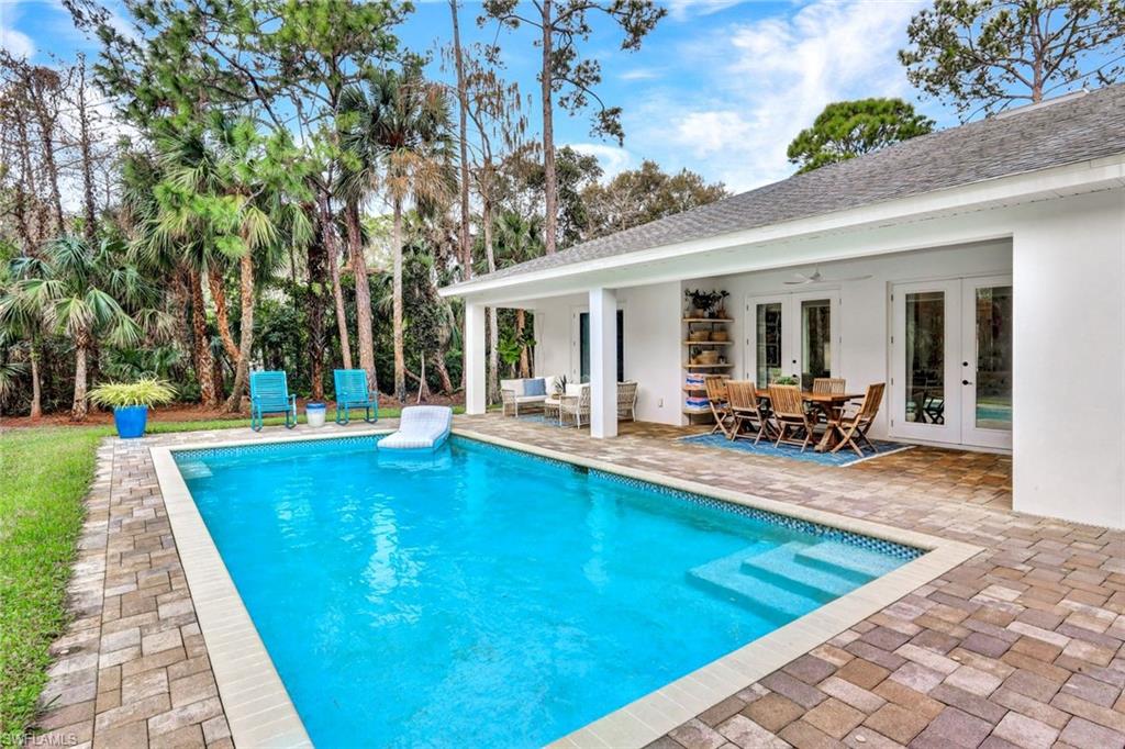 3700 11th Avenue Southwest Naples, FL 34117 - Photo 29 of 50 a view of a house with swimming pool and sitting area