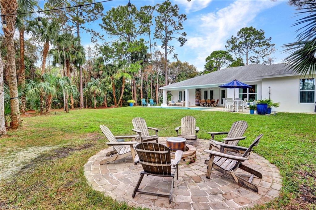 3700 11th Avenue Southwest Naples, FL 34117 - Photo 34 of 50 a view of a house with backyard sitting area and garden