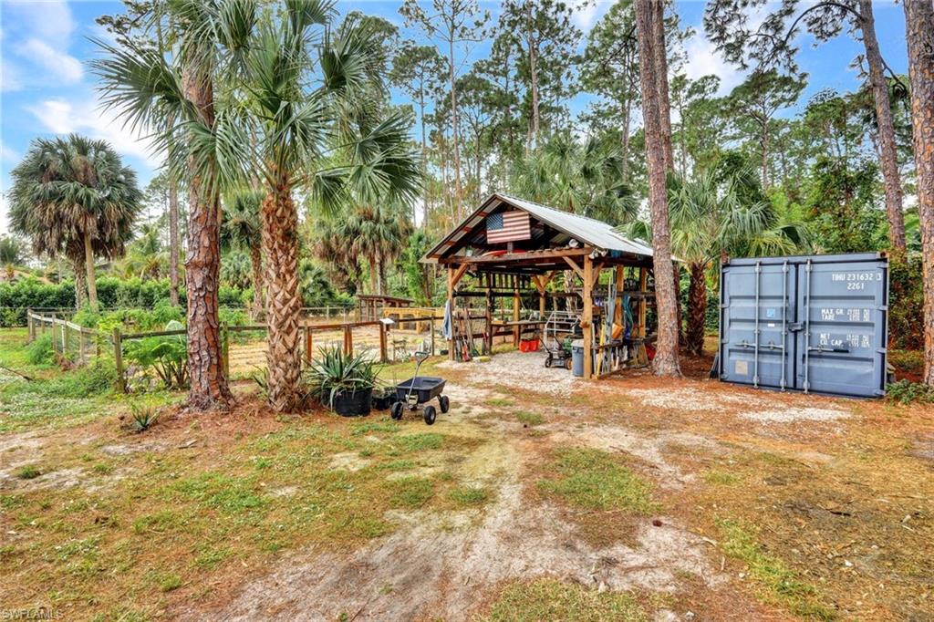3700 11th Avenue Southwest Naples, FL 34117 - Photo 35 of 50 a view of a chairs and table in the backyard of the house