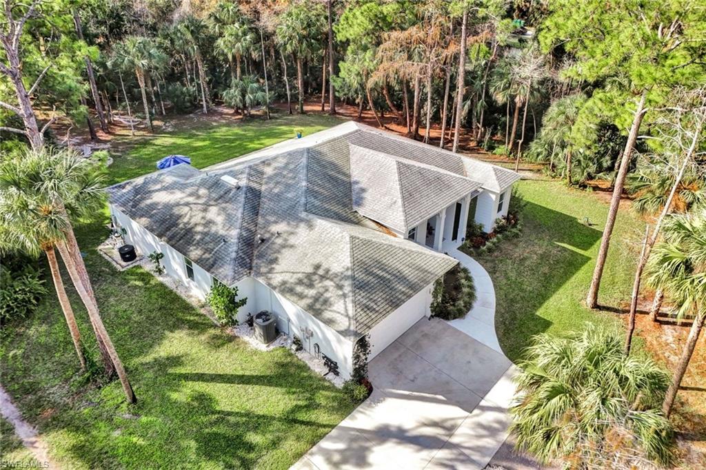 3700 11th Avenue Southwest Naples, FL 34117 - Photo 5 of 50 an aerial view of a house with a yard and large trees