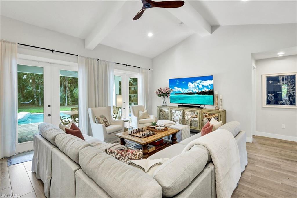 3700 11th Avenue Southwest Naples, FL 34117 - Photo 6 of 50 a living room with furniture and a flat screen tv