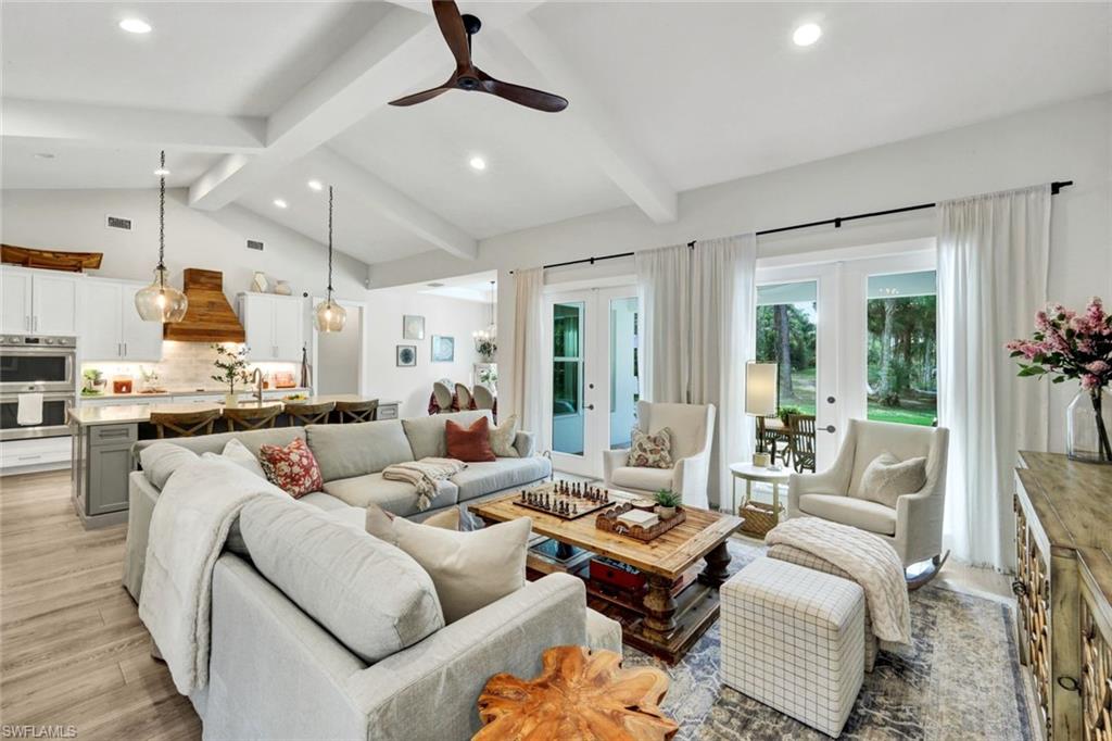 3700 11th Avenue Southwest Naples, FL 34117 - Photo 8 of 50 a living room with furniture kitchen view and a large window