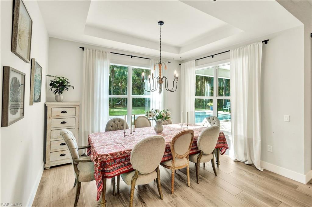 3700 11th Avenue Southwest Naples, FL 34117 - Photo 9 of 50 a view of a dining room with furniture window and wooden floor