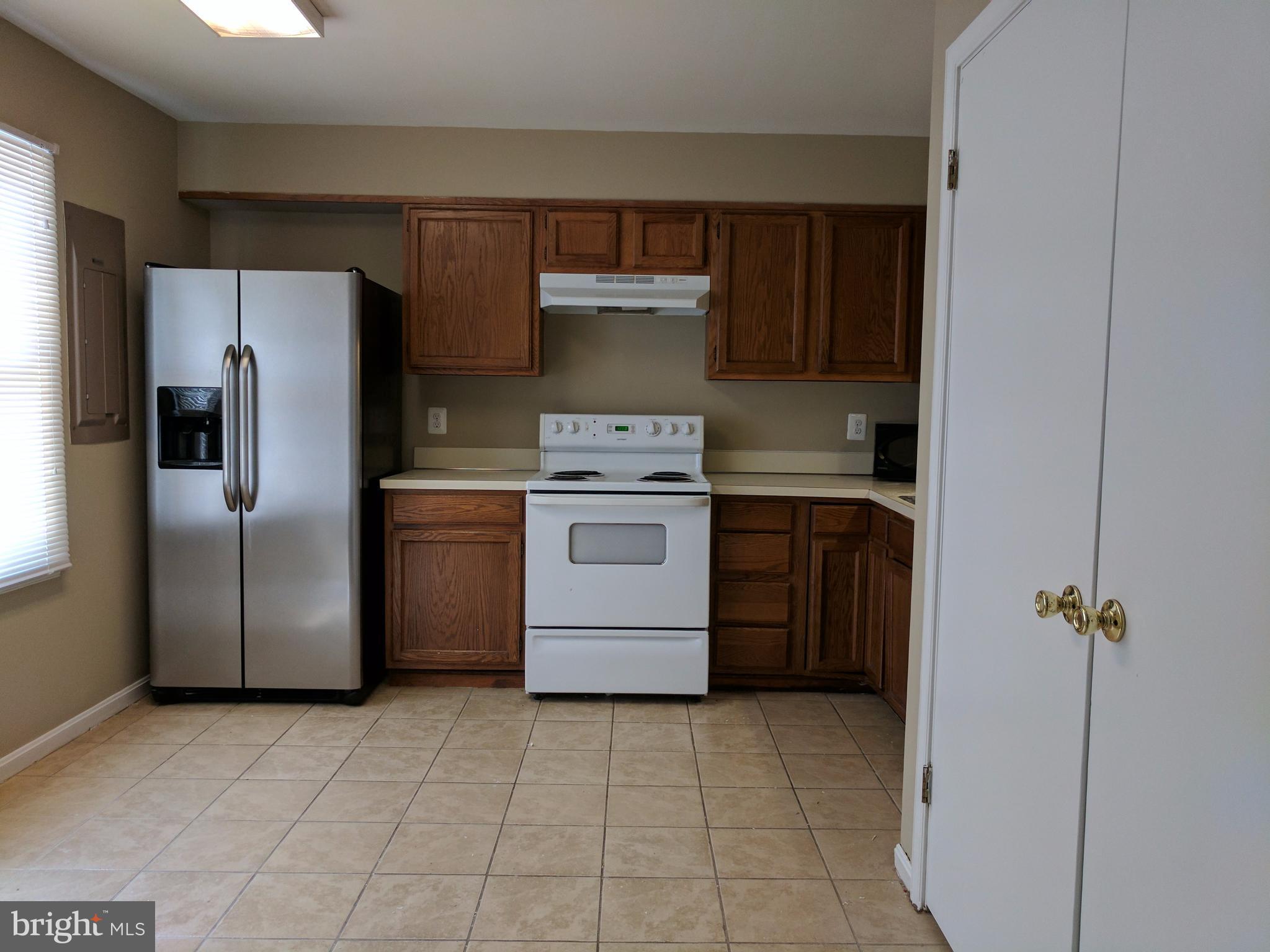 5110 Berwyn Road College Park, MD 20740 - Photo 12 of 28 a kitchen with a stove top oven and refrigerator
