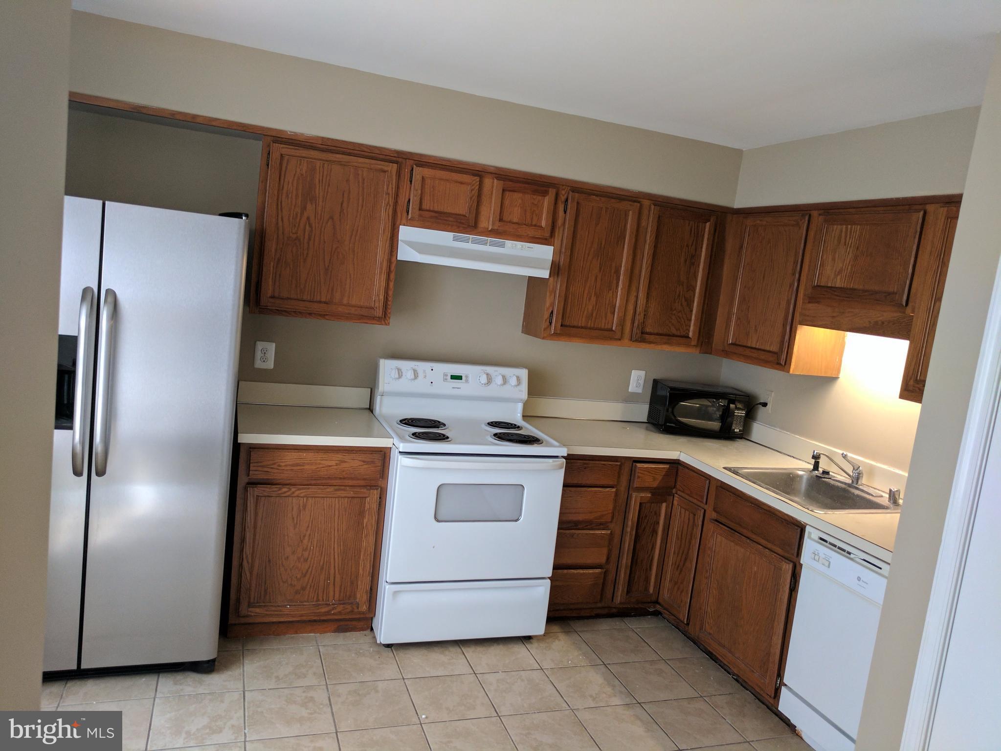 5110 Berwyn Road College Park, MD 20740 - Photo 13 of 28 a kitchen with a stove sink and refrigerator