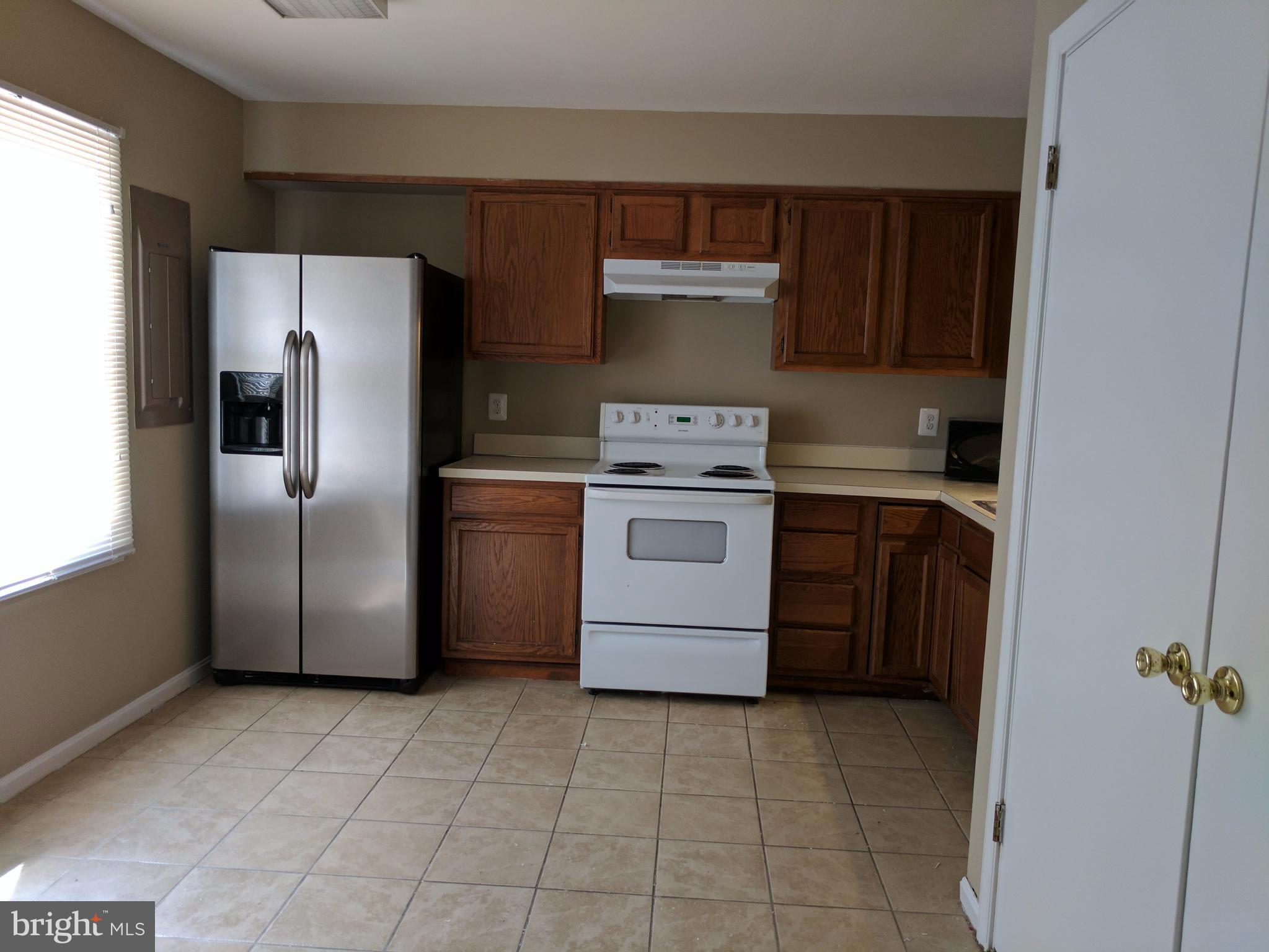 5110 Berwyn Road College Park, MD 20740 - Photo 15 of 28 a kitchen with a stove top oven and refrigerator