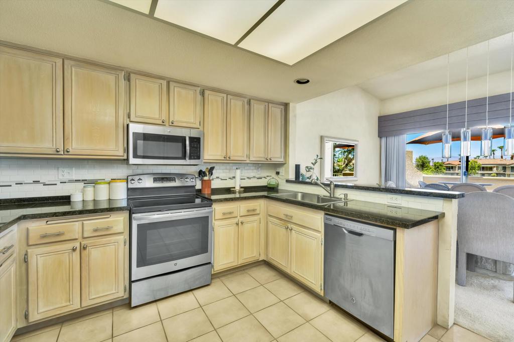 55384 Laurel La Quinta, CA 92253 - Photo 15 of 32 a kitchen with cabinets appliances and a counter top space