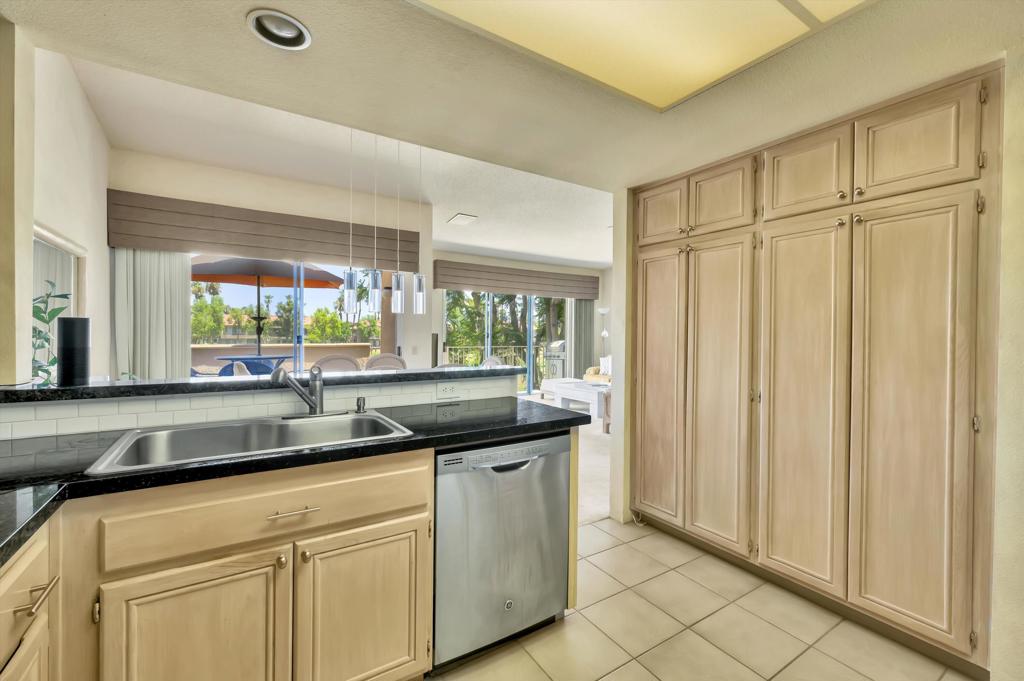 55384 Laurel La Quinta, CA 92253 - Photo 16 of 32 a kitchen with stainless steel appliances granite countertop a sink and a granite counter tops with a large window