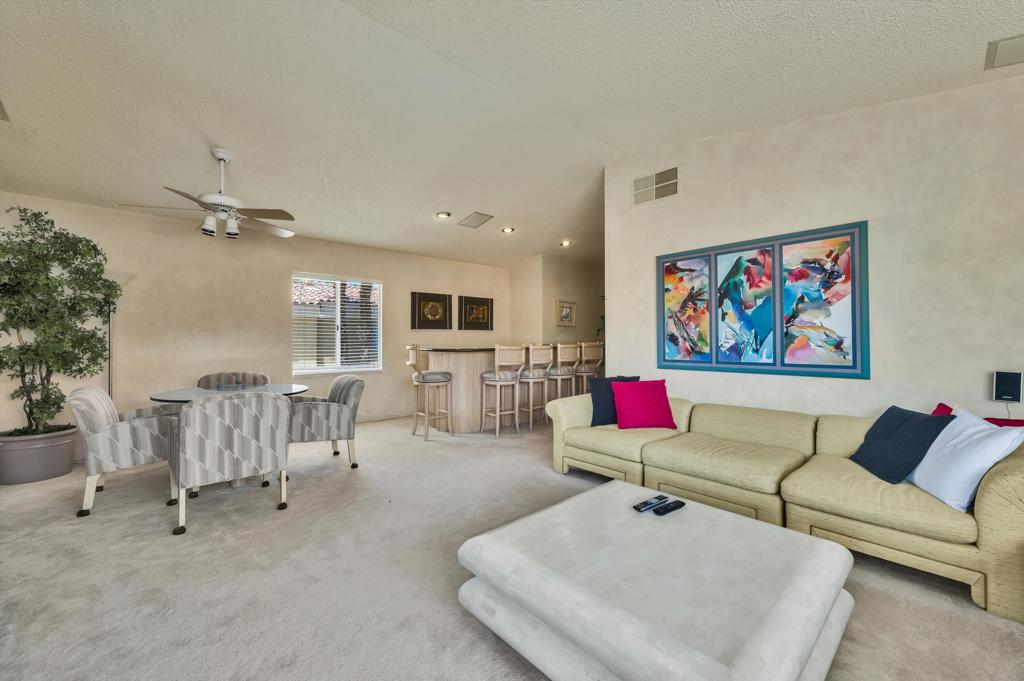 55384 Laurel La Quinta, CA 92253 - Photo 24 of 32 a living room with furniture and a flat screen tv