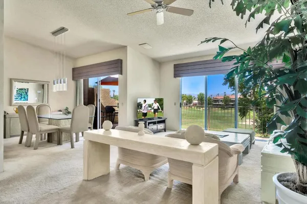 a living room with furniture and a chandelier