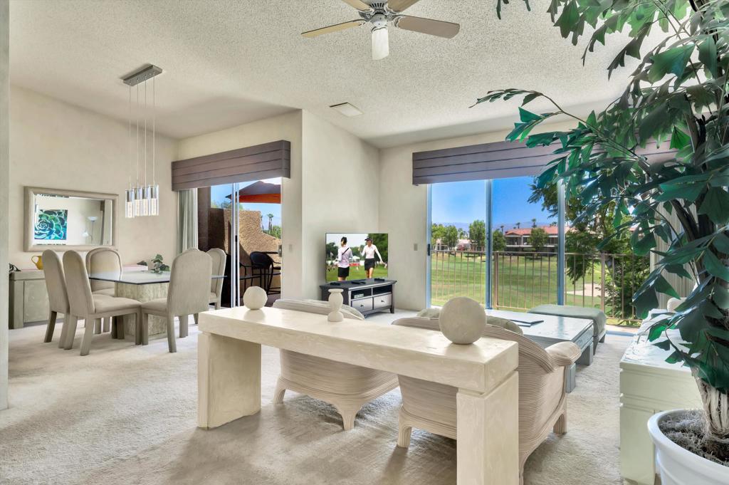 55384 Laurel La Quinta, CA 92253 - Photo 8 of 32 a dining room with furniture a floor to ceiling window and potted plants